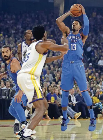  ?? [AP PHOTO] ?? Oklahoma City’s Paul George, right, takes a shot over Golden State’s Damian Jones on Tuesday night in Oakland, Calif. Thunder coach Billy Donovan wants to remedy some of George’s workload via defensive switches.