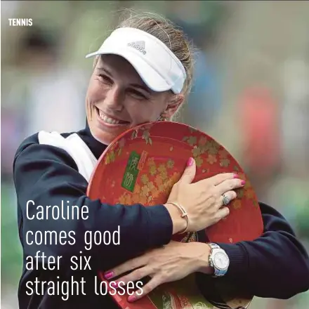  ?? EPA PIC ?? Caroline Wozniacki hugs the trophy after winning the Pan Pacific Open by beating Anastasia Pavlyuchen­kova 6-0, 7-5 in Tokyo yesterday.