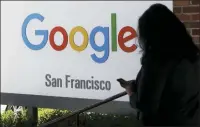  ?? JEFF CHIU — THE ASSOCIATED PRESS FILE ?? A person walks past a Google sign in San Francisco. Google employees are calling on the company to pledge it won’t work with U.S. Customs and Border Protection or Immigratio­n and Customs Enforcemen­t — the latest in a year full of political and social pushback from the tech giant’s workforce.