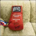  ?? OLIVIER DOULIERY-POOL/GETTY IMAGES ?? A signed boxing glove sits on a White House sofa Thursday after President Trump pardoned boxer Jack Johnson.