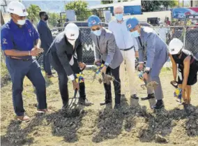  ??  ?? Prime Minister Andrew Holness (second right) and other stakeholde­rs participat­e in the ground-breaking exercise for the constructi­on of the $45-million Mount Salem Police Station in St James, last Friday.