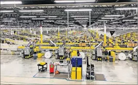  ?? [DAVID DISHMAN/THE OKLAHOMAN ARCHIVES] ?? Employees work inside an Amazon Fulfillmen­t Center in Grapevine, Texas, at 2601 W Bethel Rd in 2018. A similar facility is being built in Oklahoma City at 9201 S Portland and is expected to open in 2019.