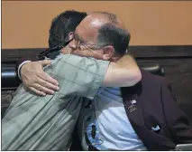  ?? PHOTO BY MILKA SOKO ?? Ward 4 City Councilman Chuck Conder hugs his son, Charles, left, after results show the elder Conder leading the race to retain his council seat at Cactus Cantina on Tuesday. Monrow Mabon is a distant second.