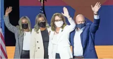  ?? NICK OZA/THE REPUBLIC ?? U.S. Sen.-elect Mark Kelly, his wife, former U.S. Rep. Gabrielle Giffords, and Kelly’s daughters, Claire, at far left, and Claudia, wave to supporters on Tuesday in Tucson.