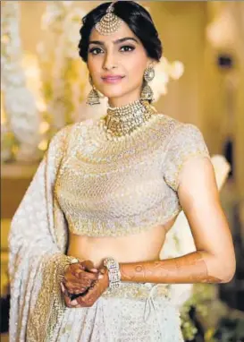  ??  ?? Actor Sonam Kapoor wore a white lehenga with golden embroidery for her sangeet function