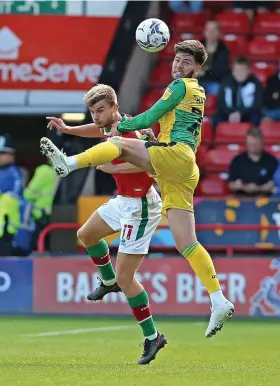  ?? ?? Rovers defender Cian Harries wins an aerial battle with George Miller