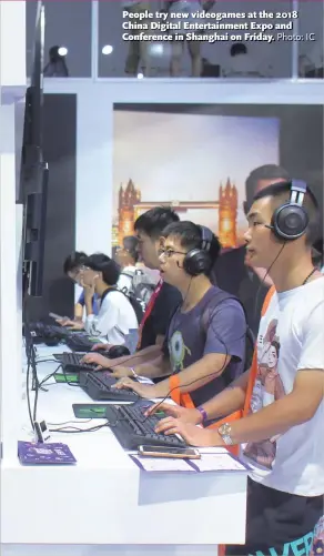  ?? Photo: IC ?? People try new videogames at the 2018 China Digital Entertainm­ent Expo and Conference in Shanghai on Friday.