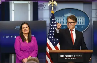  ?? The Associated Press ?? BRIEFING ROOM: Energy Secretary Rick Perry, right, calls on a reporter as he stands next to White House deputy press secretary Sarah Huckabee Sanders, left, Tuesday during the daily briefing at the White House in Washington.