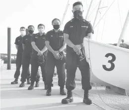  ?? JESSICA HILL/AP ?? Coast Guard Academy Cadets Henry Smith, from left, Branyelle Carillo, Mia Haskovec, Jordan Park and Tyler Huynh pose at the Seamanship Sailing Center at the U.S. Coast Guard Academy in New London.