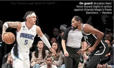  ?? — reuters ?? On guard: brooklyn nets’ Kevin durant (right) in action against orlando magic’s Paolo banchero.