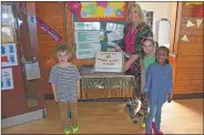  ?? 01_B24WB13 ?? Wearing outlandish shoes, Brodie Atkinson, Sera Bibin and Layla Cociuban join Mrs Shirley MacLachlan in showing off their birthday cake.