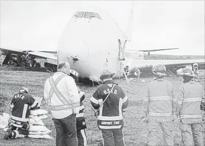  ?? ANDREW VAUGHAN THE CANADIAN PRESS ?? A SkyLease Cargo plane skidded off Runway 14 just after 5 a.m. It wasn’t clear what caused the accident that left two engines sheared off.