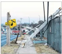  ?? $1 1)050 ?? Damaged power lines are seen in Dartmouth, N.S., on Tuesday. Thousands of Nova Scotia Power customers are without electricit­y after a Christmas Day windstorm wreaked havoc across the province, interrupti­ng dinners and disrupting travel.