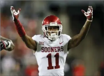  ?? PAUL VERNON — THE ASSOCIATED PRESS ?? Oklahoma cornerback Parnell Motley celebrates his intercepti­on against in the second half of the Sooners’ 31-16 victory over Ohio State. The win vaulted Oklahoma from No. 5 to No. 2 in the Associated Press top 25.