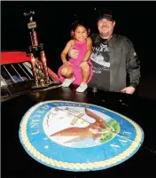  ??  ?? U.S. NAVY VETERAN AND COCOPAH SPEEDWAY FEATURE EVENT WINNER Jim Robinson poses for a photo with his daughter Alyssa in victory lane Saturday night after Robinson won the IMCA Hobby Stock Division feature event. Robinson dedicated the Memorial Day...