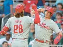  ?? KEVIN C. COX/GETTY ?? Alec Bohm and J.T. Realmuto, right, are likely candidates to hit behind Bryce Harper in the lineup.