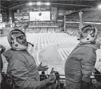  ?? Elizabeth Conley / Staff photograph­er ?? Mark Haley, left, of Katy, and Glen Tate of Bryan wear out-of-this-world costumes while cheering from the third base side during Game 2 of the World Series at Minute Maid Park.