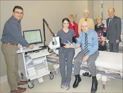 ?? SUBMITTED BY KELSEA MACNEIL ?? Dr. Laith Shimon tries out the new electromyo­graphy machine at the Glace Bay Hospital with the help of Beth Cyr, a technician and members of the Glace Bay General Hospital Charitable Foundation, Fred Courtney, far right), foundation chair, and in back from left, board members Erin Power, Glen Roach, Cathy Power and James Kerr. The equipment was purchased through a donation by the foundation.