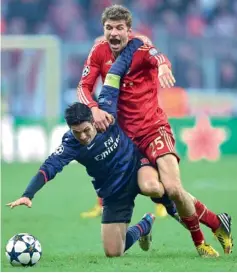  ??  ?? Bayern’s Thomas Mueller (right) was not at his best against Arsenal.