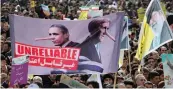  ??  ?? Iranians hold an anti- US banner during celebratio­ns in Tehran’s Azadi Square to mark the 37th anniversar­y of the Islamic Revolution on Thursday. —