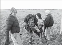  ??  ?? Peggy Farrell (left) of UW-Stevens Point shares the exuberance of a morning viewing prairie chickens at Buena Vista Wildlife Area near Plover with Bruce Bartell (center) of Onalaska and Harry Fisher of Highbridge, N.J.