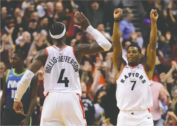  ?? FRANK GUNN/THE CANADIAN PRES FILE ?? Raptors Kyle Lowry and Rondae Hollis-jefferson celebrate a stunning comeback, defeating the Dallas Mavericks 110-107 in Toronto on Dec. 22.