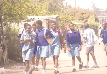  ??  ?? Pupils from George Stark High School walk home home after classes. The Mbare-based school was one of the several schools in the high-density suburbs previously categorise­d as Group B