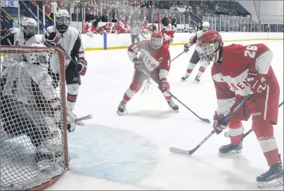  ?? DAVID JALA/CAPE BRETON POST ?? Riverview Redmen captain Josh MacKay, centre, and teammate Jacob Denny, right, strategica­lly position themselves near the crease of Halifax West Warriors goalie Justin Sumarah during second period action of this year’s Red Cup Showcase championsh­ip...