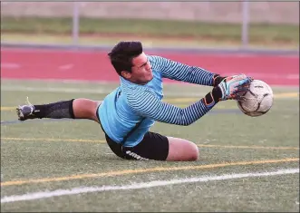  ?? Dan Watson/The Signal (See additional photos on signalscv.com) ?? Hart goal keeper Lucas Enriquez (0) blocks a shot by Los Alamitos at Hart High School on Friday.