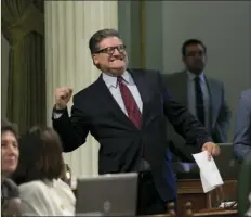  ?? AP PHOTO/RICH PEDRONCELL­I ?? State Sen. Bob Hertzberg, D-Van Nuys, pumps his fist in celebratio­n after his storm water bill was approved by the Assembly on Thursday in Sacramento. If signed by the governor, Hertzberg’s SB231 would let local government­s charge residents for storm...