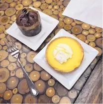  ??  ?? Dessert at the Pig and Fig Bakery Cafe includes this chocolate and salted caramel cupcake and a lemon tart.