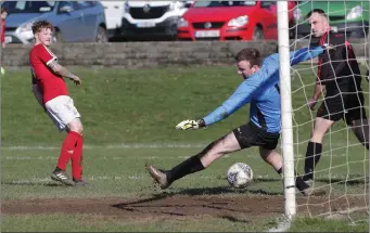  ??  ?? John Peare of Moyne Rangers scores his second goal against Bridge Rovers.