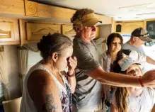  ?? The Associated Press Photos by Noah Berger, ?? Kimberly Price wipes tears from her eyes while receiving a donated motorhome from Emergencyr­v.org founder Woody Faircloth, center, on Sept. 5 in Quincy, Calif.