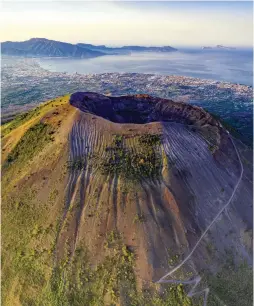  ??  ?? The Mount Vesuvius volcano, another subject of muon tomography investigat­ion, looms over the Italian city of Naples BELOW