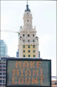  ?? (AP/Wilfredo Lee) ?? A flashing sign near the Freedom Tower in downtown Miami encourages residents to participat­e in the 2020 census.