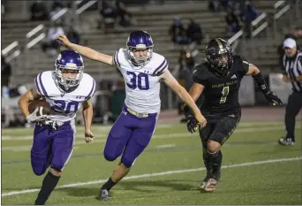  ?? Bobby Block/The Signal ?? (Above) Valencia’s Caden Harrington (20) sprints ahead of a pursuing Golden Valley player while defended by teammate Ty Morrison (30) Friday at Canyon High. (Below) Golden Valley’s Jared Giles (28) tries to evade a group of pursuing Valencia players during the game.