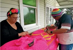  ?? CHRISTIAN COLE/SUPPLIED ?? Lissy and Rudi Robinson-Cole work on one of their dayglo pou ‘‘carvings’’. The couple collaborat­es on all aspects of their work.