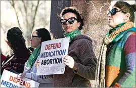  ?? DAVID ERICKSON / AP ?? Lindsay London holds a protest sign in front of the federal courthouse in support of access to abortion medication on Wednesday in Amarillo, Texas.