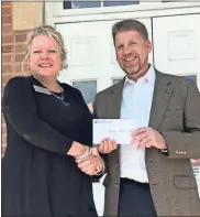  ?? / Contribute­d ?? DAPC President Missy Kendrick received a check from Carroll EMC President Tim Martin following a Thursday lunch held to thank his organizati­on for the donation.