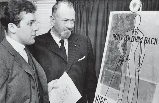  ?? Associated Press file photo ?? Nobel prize-winning author John Steinbeck, right, admires a prize-winning poster by his son, Thomas Steinbeck, in Hartford, Conn., March 22, 1963. A tender and touching letter that author John Steinbeck penned to his teenage son, offering fatherly advice after the young man confided that he was in love for the first time, is going up for auction. "If you are in love — that's a good thing — that's about the best thing that can happen to anyone. Don't let anyone make it small or light to you," the Nobel literature laureate told his son, Thomas, in 1958.