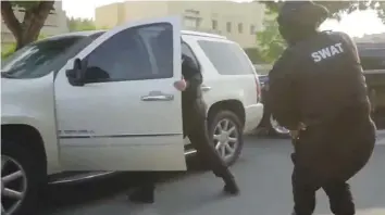  ??  ?? A video grab of the Swat operatiion in Dubai. Drug trafficker­s Benjamin Neil and Mathew John were planning to leave the UAE, but their plan was foiled by Dubai Police.