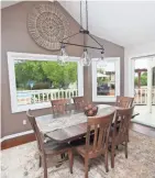  ??  ?? The dining area in the kitchen looks out onto the backyard.