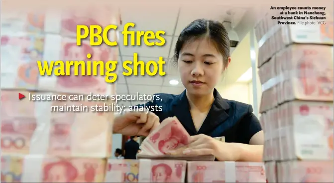  ?? File photo: VCG ?? An employee counts money at a bank in Nanchong, Southwest China’s Sichuan Province.