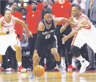  ?? Kin Man Hui / San Antonio Express-News ?? Patty Mills steals the ball from the Rockets’ Eric Gordon (right) in Game 3 of their series.