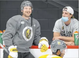  ?? Erik Verduzco Las Vegas Review-journal @Erik_verduzco ?? Knights defenseman Shea Theodore, left, and teammate Marc-andre Fleury, wearing a different kind of mask, take a break at a recent practice.