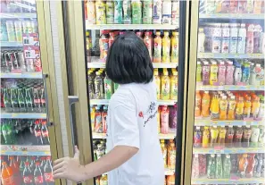  ?? PATIPAT JANTHONG ?? Fruit juices and ready-to-drink beverages at a convenienc­e store. A source says the new requiremen­t for juices is expected to take effect from Oct 1.