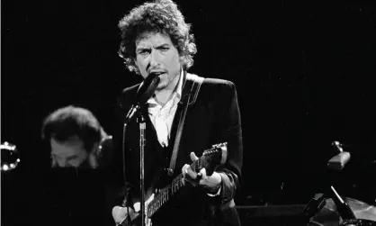  ?? Photograph: Jeff Robbins/AP ?? Bob Dylan performs at the Forum in Los Angeles in 1974.