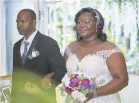  ??  ?? The bride is escorted up the aisle by her uncle Byron Campbell.