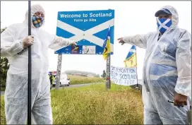  ??  ?? keeP OUT: PPE-clad protesters urge motorists not to cross Border yesterday
