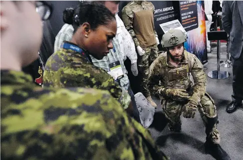  ?? JUSTIN TANG / THE CANADIAN PRESS ?? Simon Forget of Mawashi demonstrat­es the UPRISE tactical exoskeleto­n at the Canadian Associatio­n of Defence and Security Industries Cansec trade show in Ottawa on Wednesday.